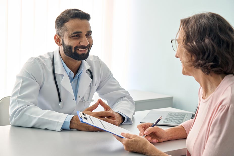 happy-doctor-consulting-senior-patient